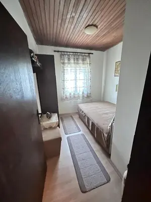 a small bedroom with a bed and a window at Kaldrmica in Gornji Brčeli