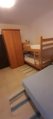 a small room with a bed and a table at Guest house Ruzica in Sutomore