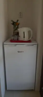 a white appliance sitting on top of a refrigerator at Guest house Ruzica in Sutomore