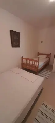 two beds in a small room with two beds at Guest house Ruzica in Sutomore