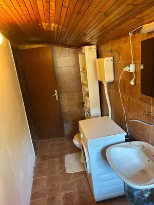 a small bathroom with a toilet and a sink at Family Guest House in Ulcinj