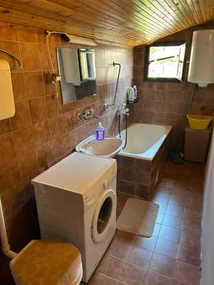 a bathroom with a washing machine and a sink at Family Guest House in Ulcinj