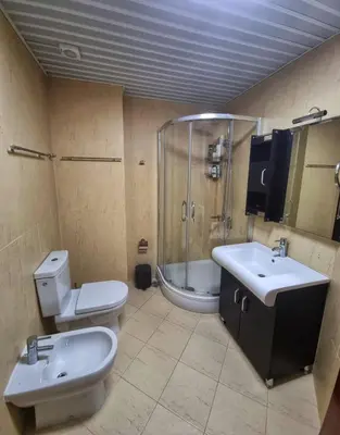 a bathroom with a toilet and a sink and a shower at Baby Blue Apartments in Bar
