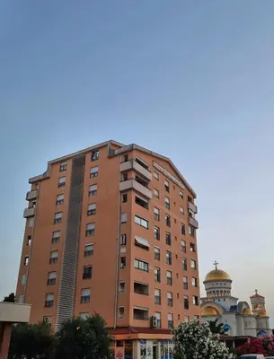 a tall brick building with a dome on top of it at Baby Blue Apartments in Bar