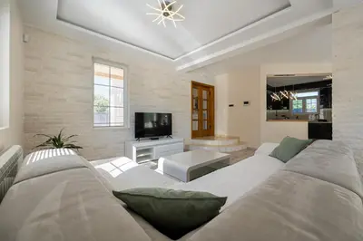 a living room with a couch and a tv at Villa Stemi in Tivat
