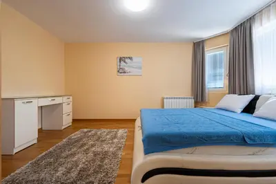 a bedroom with a blue bed and a window at Villa Stemi in Tivat
