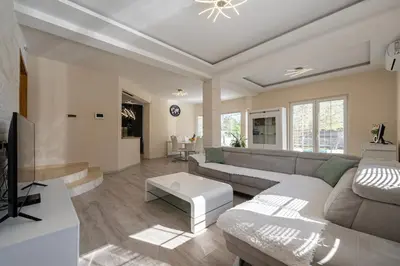 a living room with a couch and a tv at Villa Stemi in Tivat