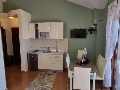 a kitchen with a sink and a table with chairs at Villa Perla with Sea View in Bar