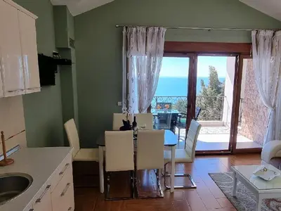 a kitchen and dining room with a table and a view of the ocean at Villa Perla with Sea View in Bar