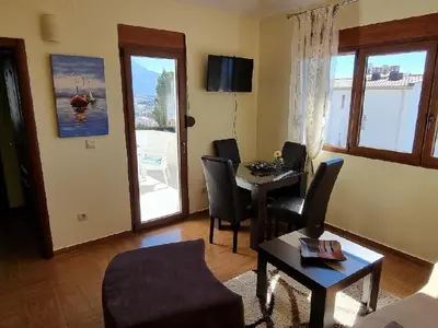 a living room with a table and chairs and a living room at Villa Perla with Sea View in Bar