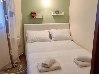 a bed with two pillows on it in a room at Villa Perla with Sea View in Bar