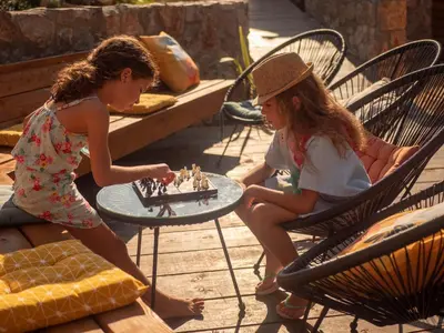two young girls playing a game of chess at Sea Glamping in Kotor
