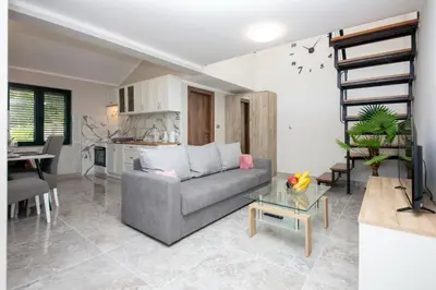a living room with a couch and a table at Fortress View apartment II in Kotor