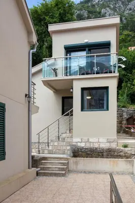 a house with a glass balcony on top of it at Fortress View apartment II in Kotor