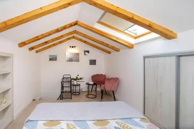 a bedroom with a bed and a table at Apartment Sara with seaview in Budva