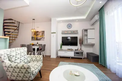 a living room with a couch and a tv at Apartment Sara with seaview in Budva