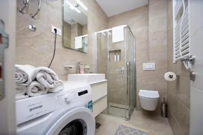a washing machine in a bathroom with a washer at Apartment Sara with seaview in Budva