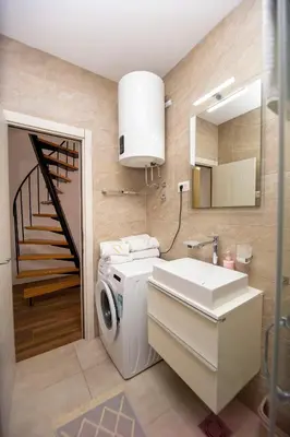 a bathroom with a washing machine and a sink at Apartment Sara with seaview in Budva