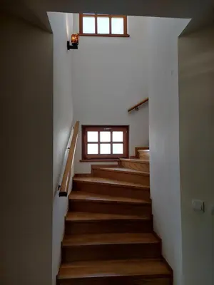 a staircase in a house with wooden floors and a window at Luxury Home Cetinje in Cetinje
