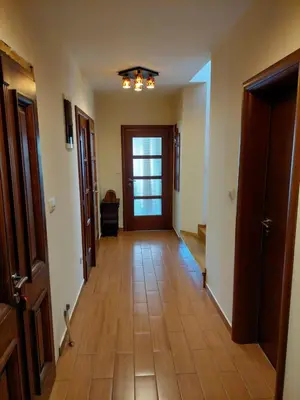 a hallway with a wooden floor and a door at Luxury Home Cetinje in Cetinje