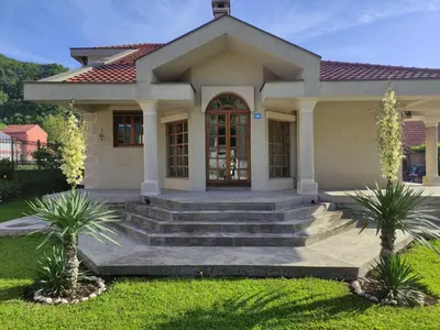 a small house with a staircase leading to the front door at Luxury Home Cetinje in Cetinje