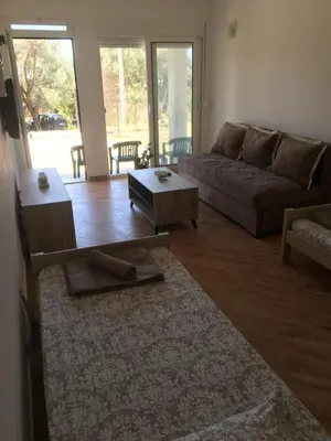 a living room with a couch and a coffee table at Studio Apartman Susanj Bar in Bar