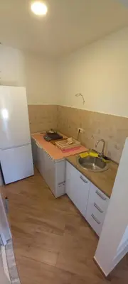 a kitchen with a counter and a sink and a refrigerator at Studio Apartman Susanj Bar in Bar