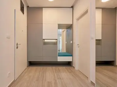 an empty room with a hallway with a mirror at AURA TOWER Apartments by Gaby in Rafailovici