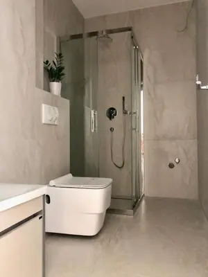 a bathroom with a shower with a toilet and a sink at AURA TOWER Apartments by Gaby in Rafailovici