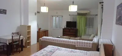 a living room with a couch and a tv at VuJo in Sutomore