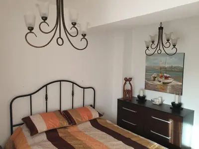 a bedroom with a bed and a painting on the wall at Mari in Ulcinj