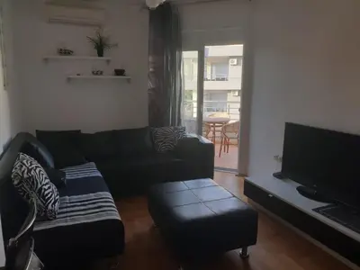 a living room with a couch and a flat screen tv at Mari in Ulcinj