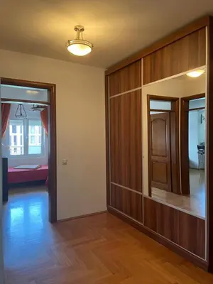 a room with a hallway with a door and a bedroom at Mari in Ulcinj