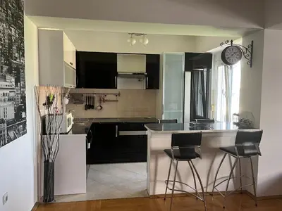 a kitchen with a counter and some chairs in it at Mari in Ulcinj
