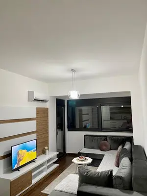 a living room with a couch and a flat screen tv at Capitol Apartments in Ulcinj