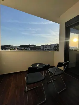 a room with a table and two chairs and a window at Capitol Apartments in Ulcinj