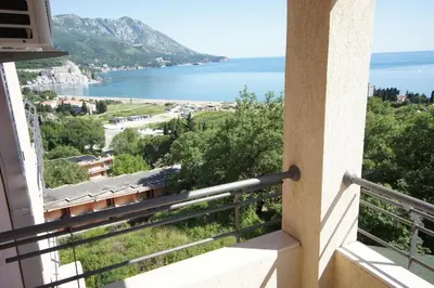 a view of the ocean from a balcony of a building at Apartments Bečići Sunset in Budva