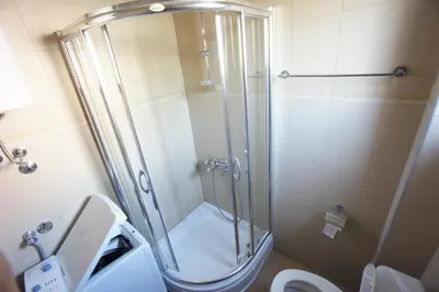 a bathroom with a shower with a toilet and a sink at Apartments Bečići Sunset in Budva