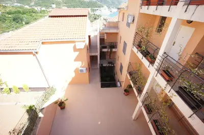 an empty courtyard of a building with plants at Apartments Bečići Sunset in Budva