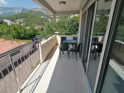 a balcony with a table and chairs on it at Apartman Sara in Pržno