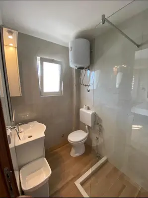 a bathroom with a toilet and a sink and a shower at Heaven Home in Ulcinj