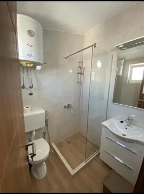 a bathroom with a shower and a toilet and a sink at Heaven Home in Ulcinj
