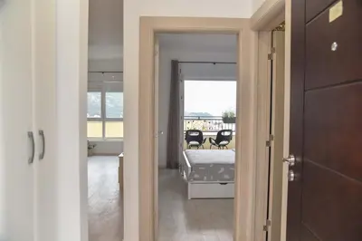 a view of a bedroom with a bed and a balcony at Full of light, relaxing, calming apartment in BD in Budva