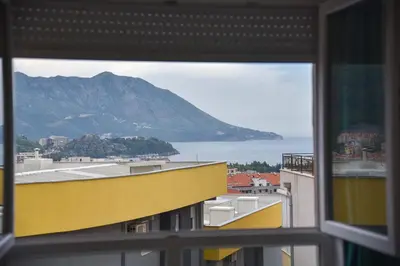 a view of a mountain from a window at Full of light, relaxing, calming apartment in BD in Budva