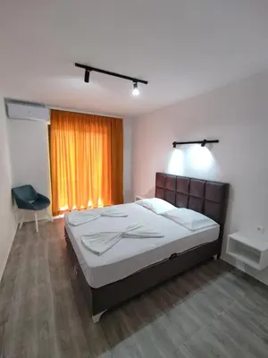 a bedroom with a large bed and a window at Horizont Dobre Vode in Dobra Voda