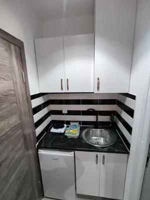 a small kitchen with a sink and white cabinets at Horizont Dobre Vode in Dobra Voda