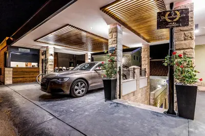 a car parked in front of a house at Dekaderon Lux Apartments in Kotor