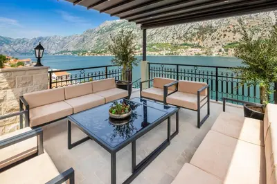 a patio with a view of the water at Dekaderon Lux Apartments in Kotor