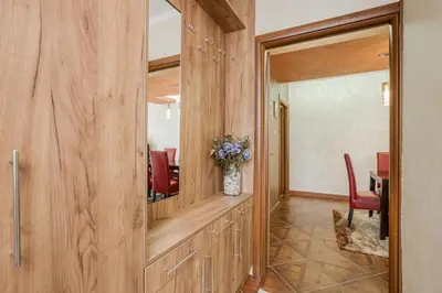 a hallway with a dining room with red chairs at Dekaderon Lux Apartments in Kotor