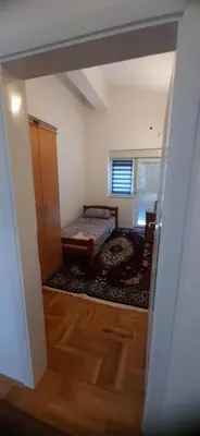 a room with a bedroom with a bed and a door at Apartmani Paradise in Sutomore
